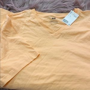 Peach colored short sleeve shirt